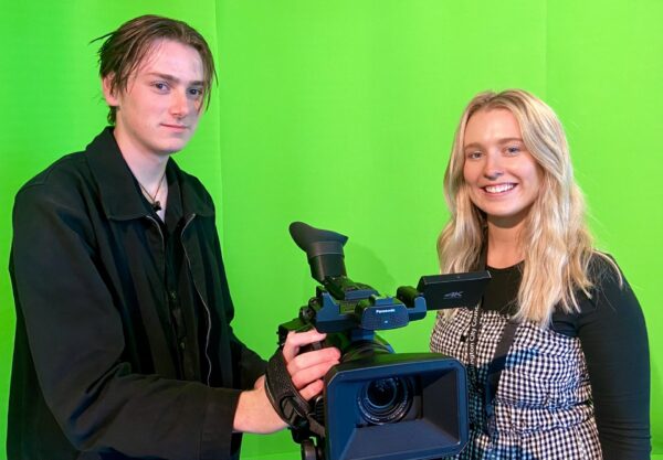 Photo of Learning Specialists Finn and Chelsea in the OnTV studio with a camera