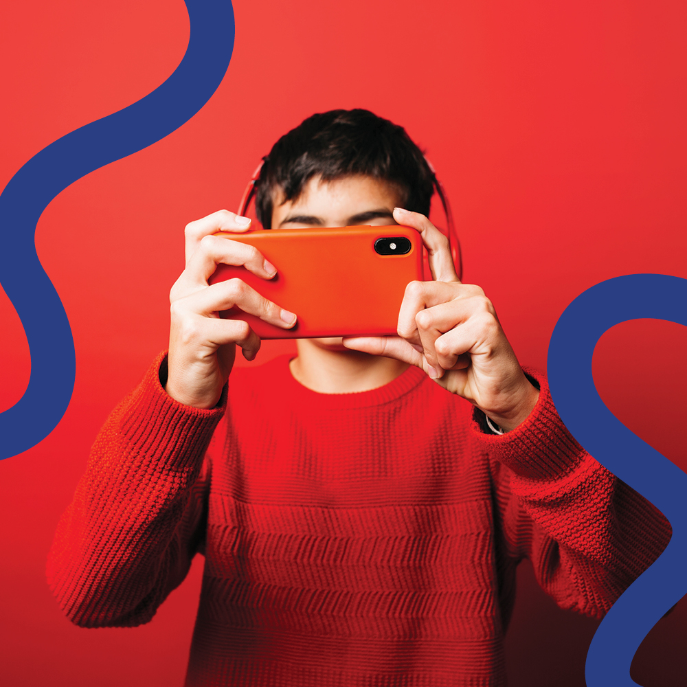 A young photographer holds a camera