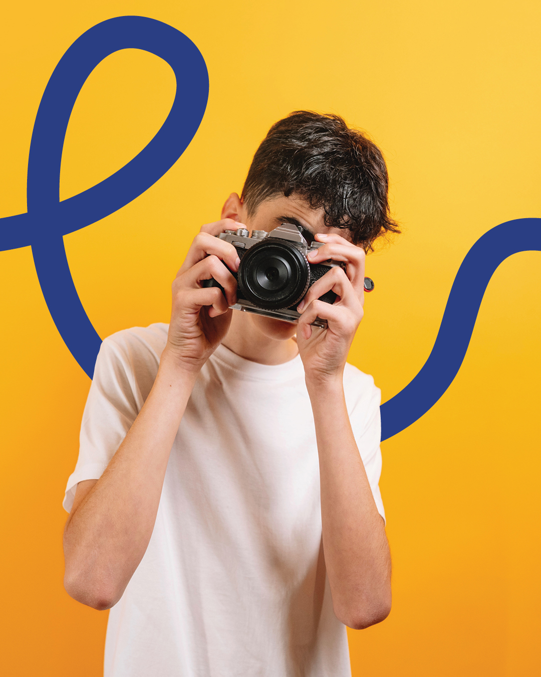 A young photographer holds a camera