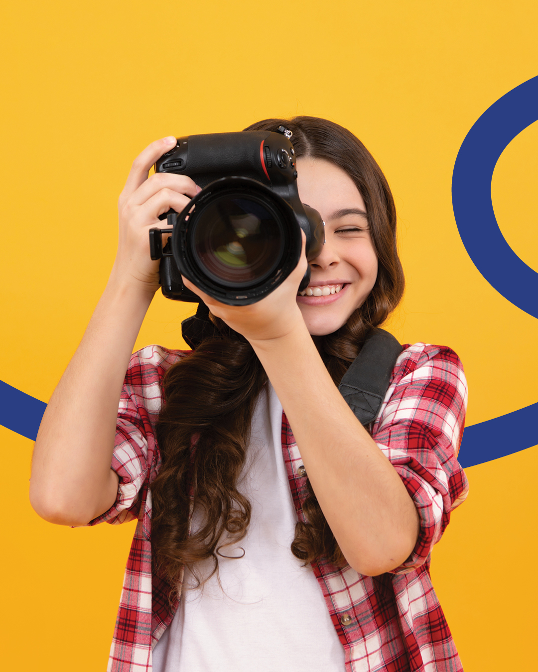A young photographer holds a camera