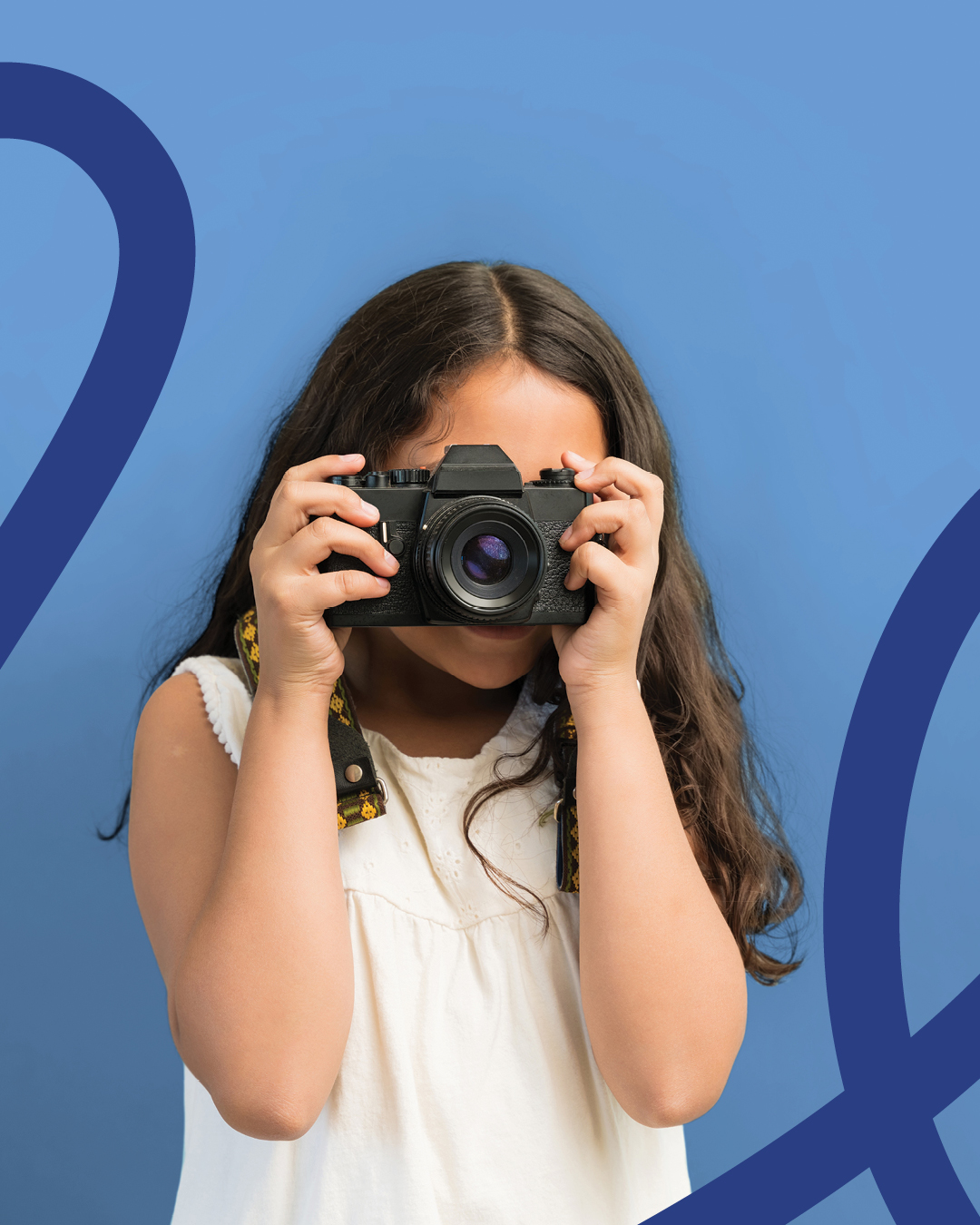 A young photographer holds a camera